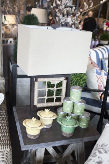 Get your patio ready for spring: Outdoor lamp and candles on a side table help to light the space.