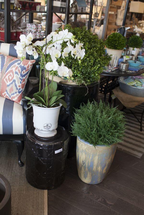 Get your patio ready for spring: Planters in gray, black and neutral colors are used to define a seating space.