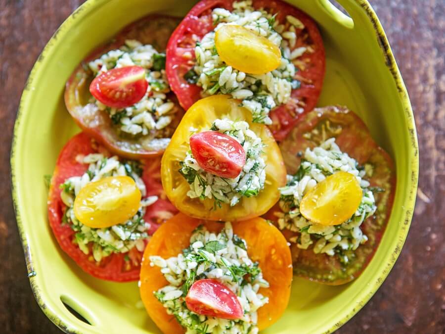 This recipe for Heirloom Tomatoes with Herbed Orzo Salad is a hit at summer soirÃ©es! Scroll down for the recipe link.