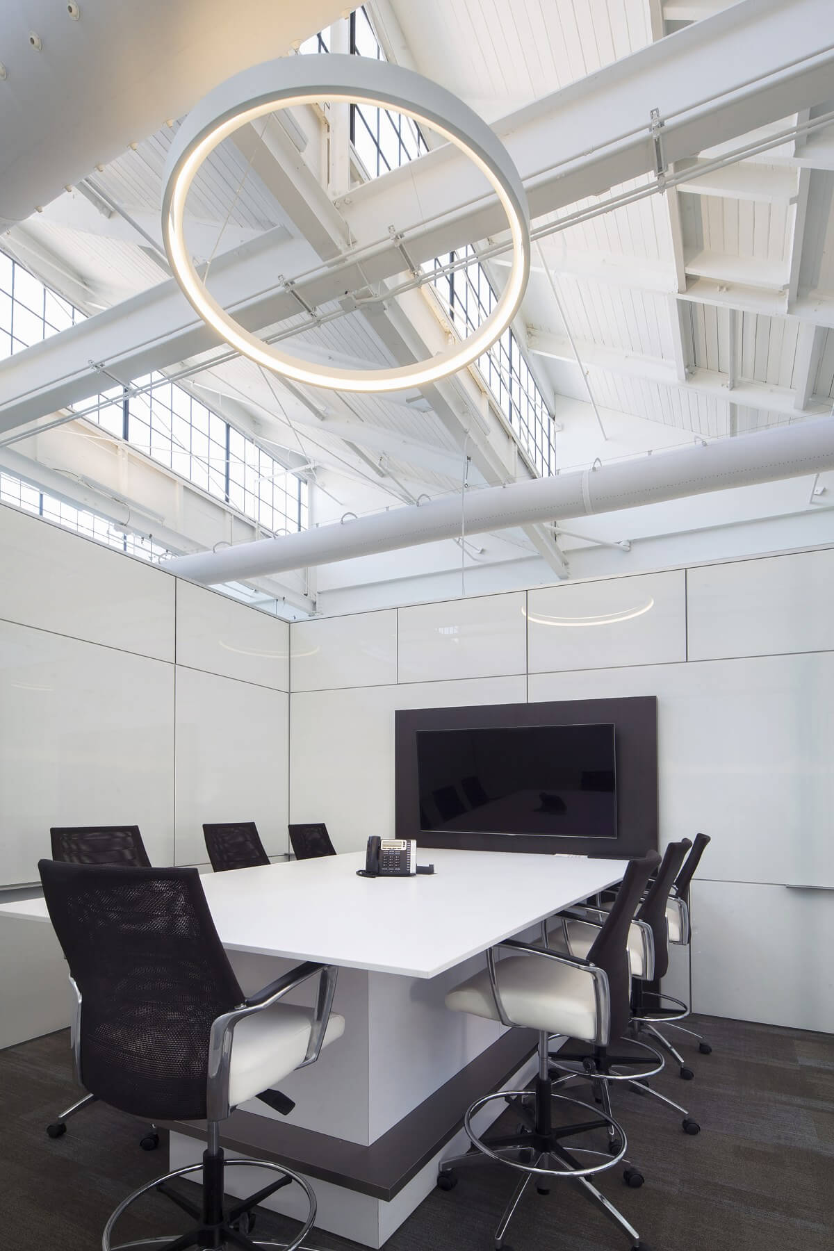 Unique circular lighting makes a simple yet stunning statement in this one-of-a-kind conference room Image Mason Fischer