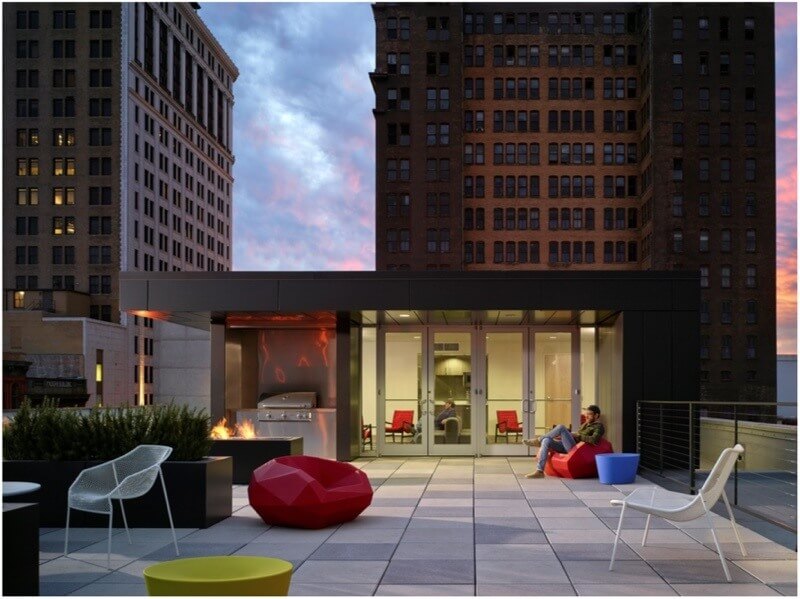 The roof features a glass and steel pavilion as well as pavers planters a fire pit and a grill to create a comfortable relaxing environment among the Magic City skyscrapers Image Luker Photography