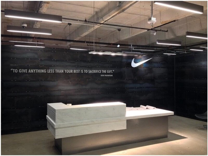 The sleek contemporary Alabama marble reception desk against the backdrop of the blue mill steel  both quintessential materials of Birmingham  greets visitors of the Nike office and showroom Image Seth Chandelor