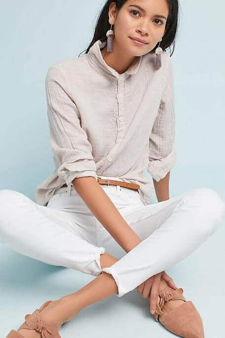 Pair your white jeans with spring-appropriate tops like this casual-chic eggshell blouse. Image: Anthropologie