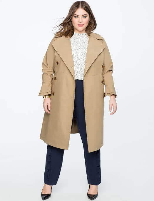For transitional weather, a lightweight trench coat in a neutral shade is a wardrobe workhorse. Image: Eloquii