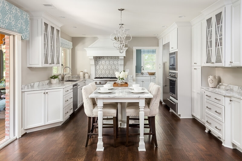 Muted blues and grays dance with ivory and cream in this elegant kitchen. 
