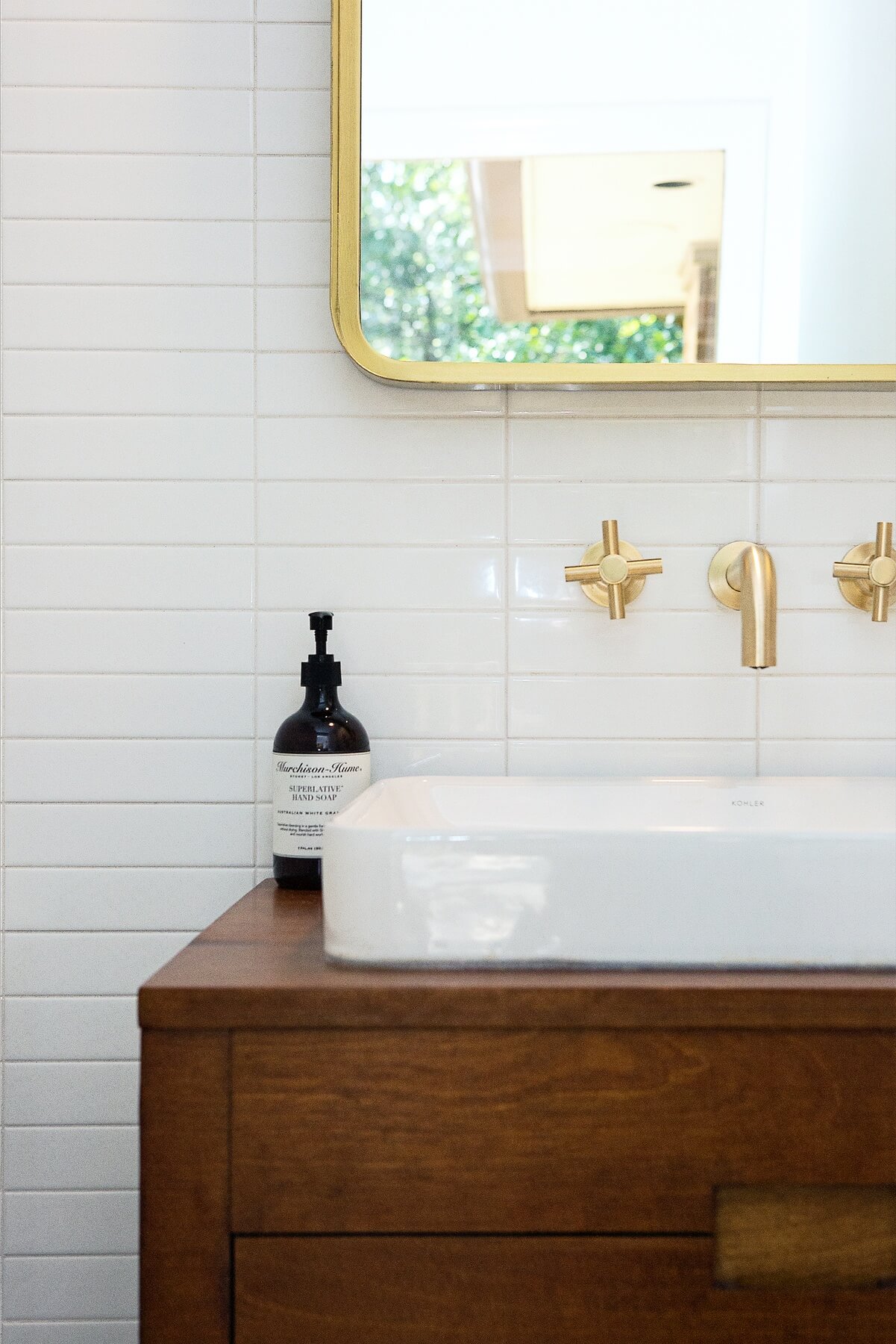 Alima loves to design bathrooms. "Choosing plumbing fixtures and mirrors and cabinet hardware is like choosing jewelry to accent an outfit," she says. "So many pretty options — I feel like a kid getting to play dress up!" Image: Ashley Lauren Studios