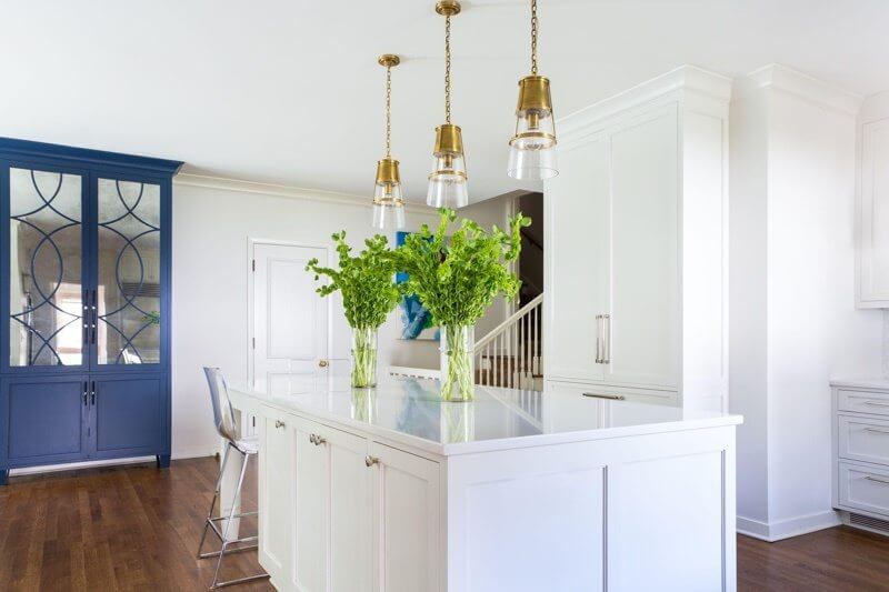 A pop of blue makes a fabulous statement in this all-white kitchen.