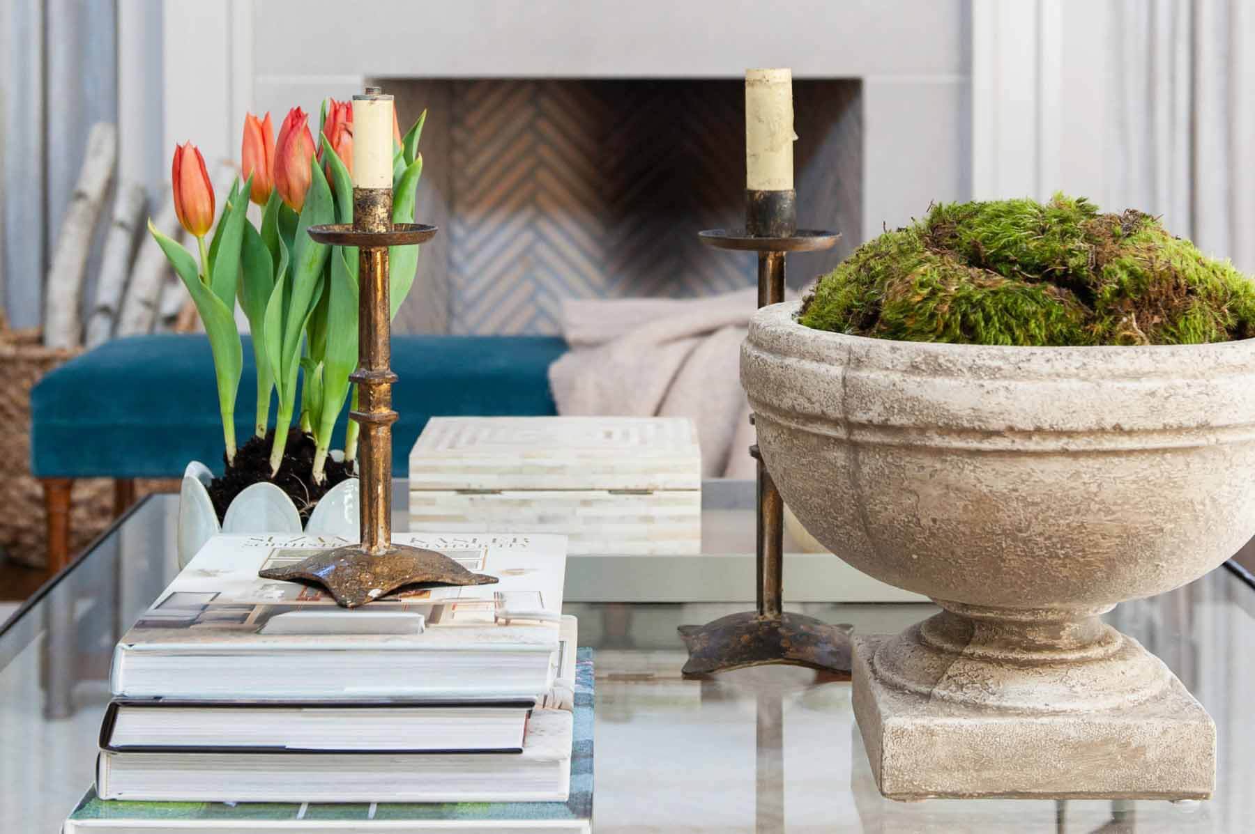 Debbie Matthews design vignette with antique candlesticks, books, tulips and greenery