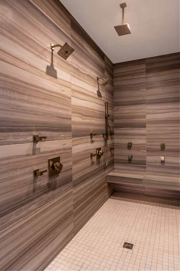 The zero-entry, his-and-hers shower in the master bathroom
