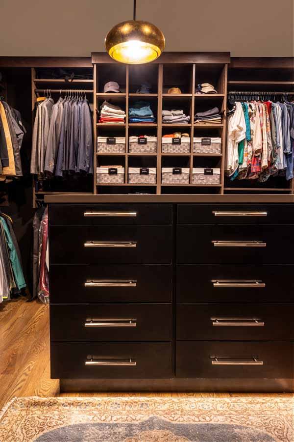 His and hers closet from the Closet Company, with a dark wood island in the center