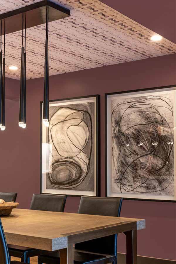 Black and white dining room art contrasts the plum walls and Eskayel ceiling.